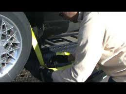 Driver using an over the wheel strap to secure a car